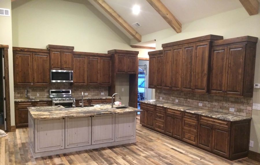 Knotty alder kitchen with a distressed painted island