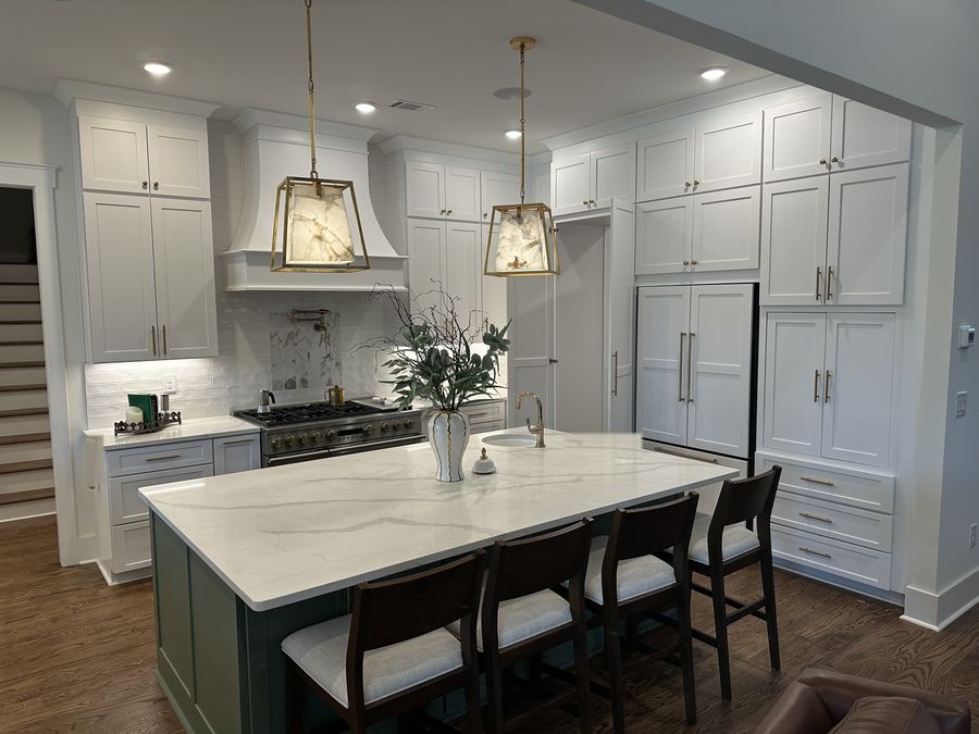 Custom kitchen with wood range hood and painted island